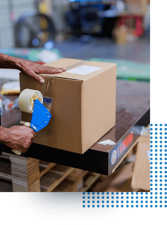 Pegasus Team member taping a box for shipment