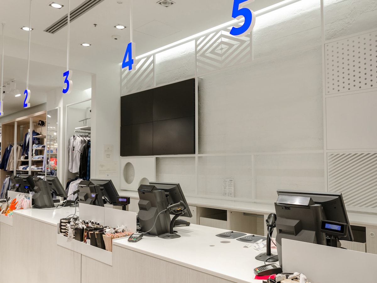 Counter with cash registers and monitors in a large store dressing room
