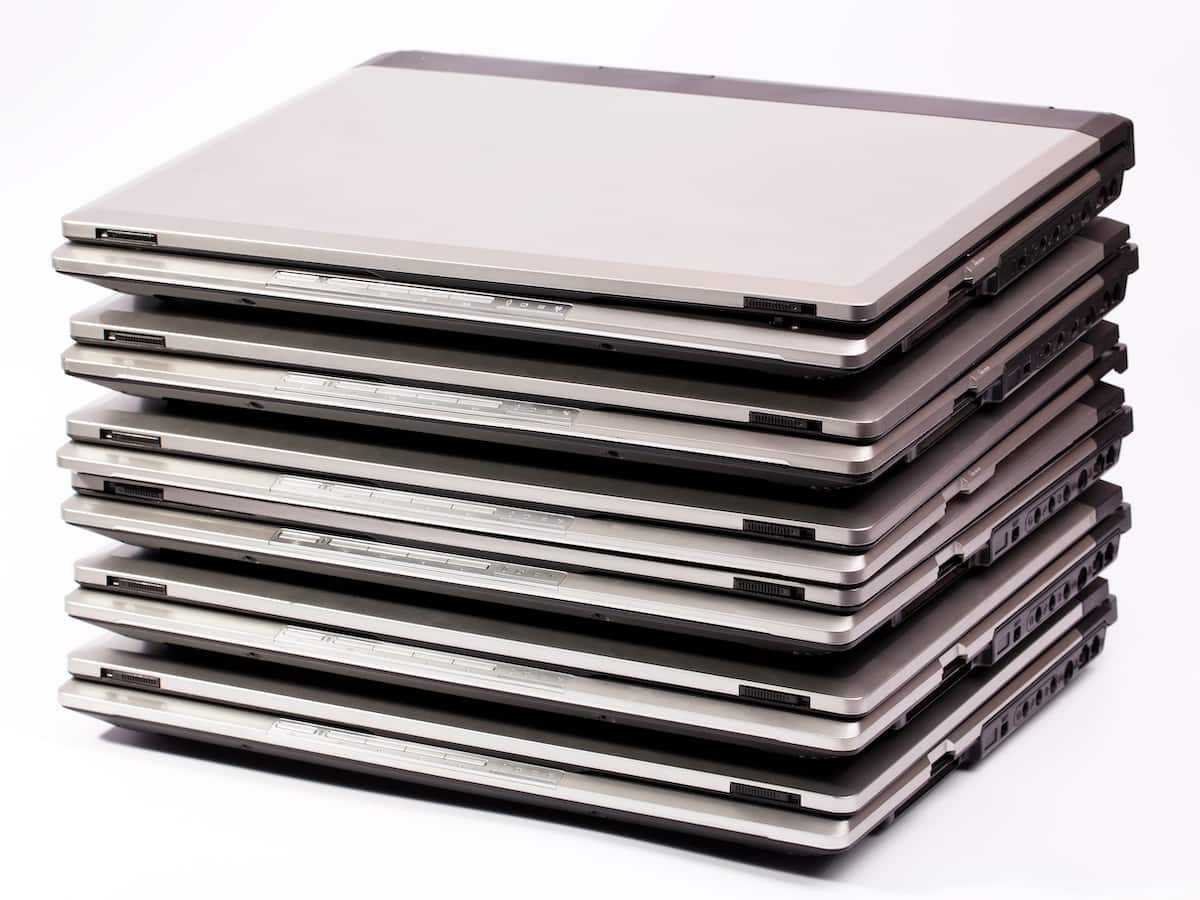 Pile of laptops on the white background